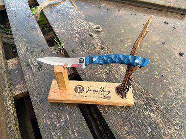 blue handled pit pony hunting knife on stand